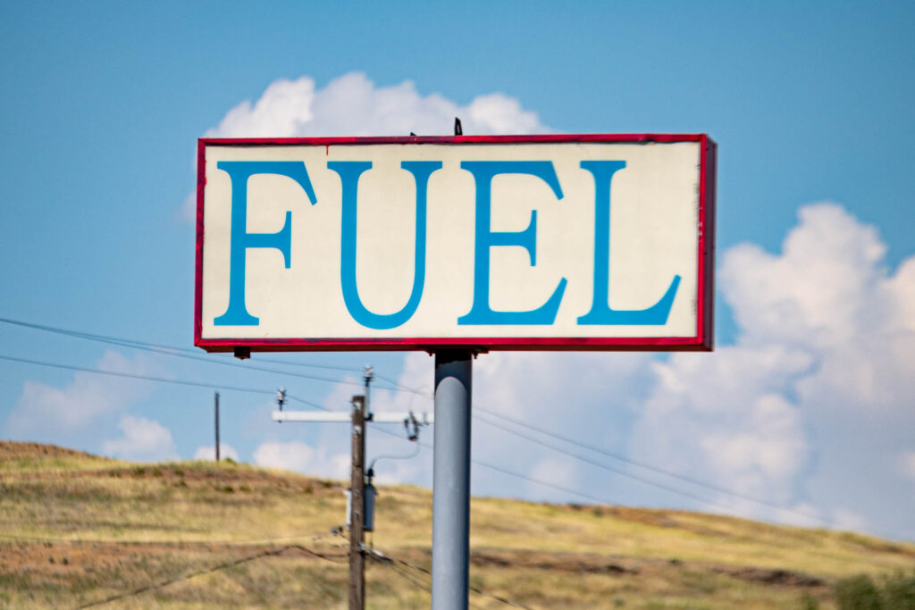 A Fuel sign that could be from a model railroad rises above the parched ground in Washtucna, Washington. The off-brand store gas station provides the only major services in town.