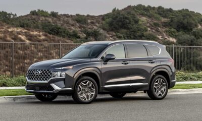 A picture of a 2022 Hyundai Santa Fe SUV in dark charcoal pictured on a road in a desert area