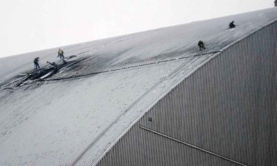 Firefighters and engineers on the roof of the protective structure over Reactor 4 at Chornobyl Nuclear Power Plant after the 14 February Russian drone attack.