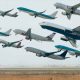 A picture of multiple airplanes leaving an airport