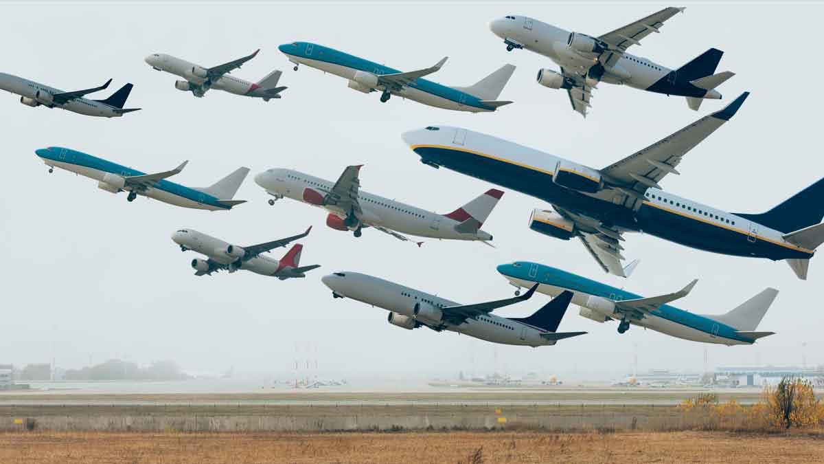 A picture of multiple airplanes leaving an airport