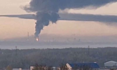 The Yaroslavl Oil Refinery near Moscow is on fire with a large black plume of smoke rising into the air at sunrise.