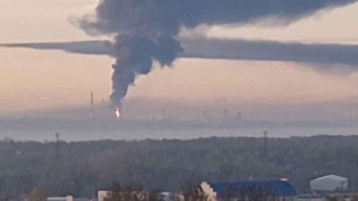 The Yaroslavl Oil Refinery near Moscow is on fire with a large black plume of smoke rising into the air at sunrise.