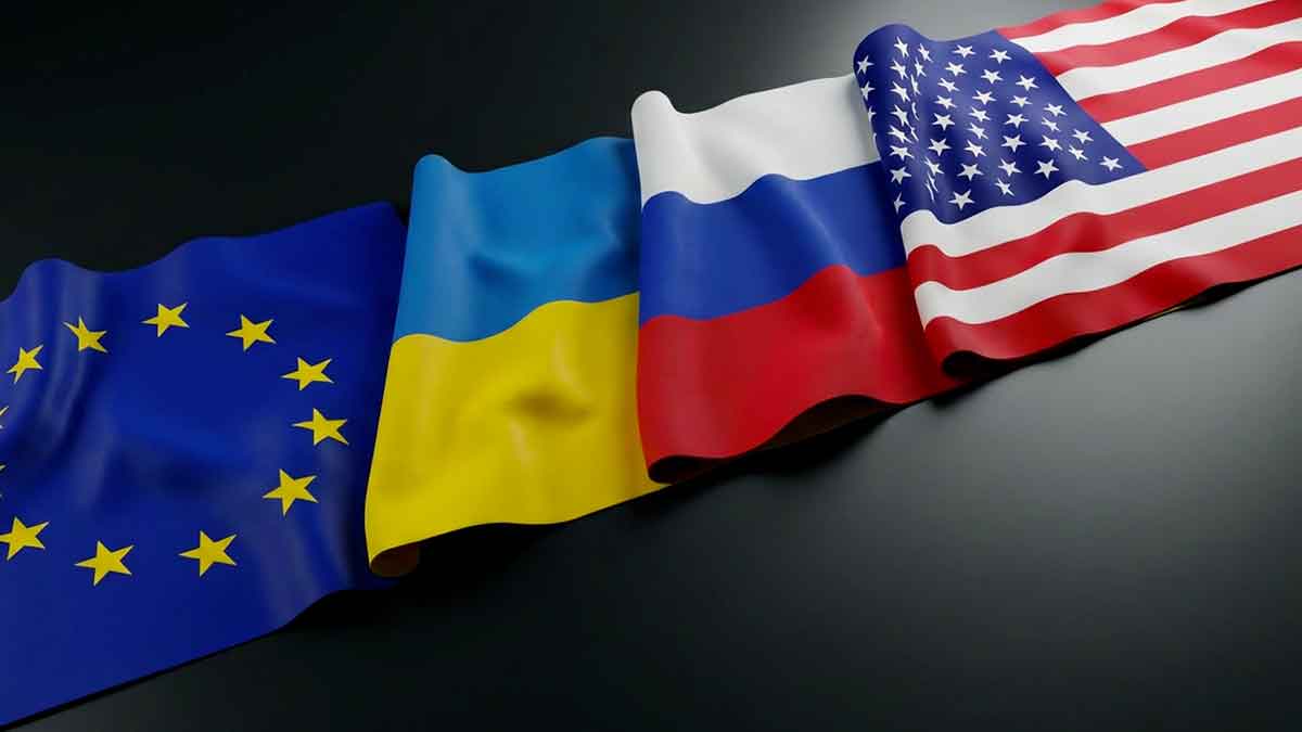 Flags of the European Union, Ukraine, Russia, and the United States lying on a table.